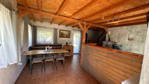 a dining room with a wooden table and chairs at Domek Adusiówka in Stronie Śląskie