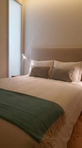 מיטה או מיטות בחדר ב-GuestReady - Catorze de Outubro Houses 427