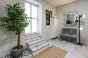 a living room with a tree and a chair at GuestReady - Miragaia Historical Sight in Porto