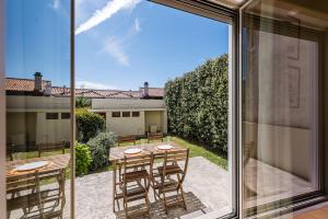 a view of a patio with a table and chairs at GuestReady - City & Beach Garden Home in Porto