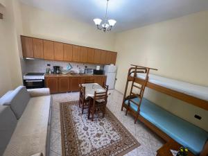 a living room with a bunk bed and a kitchen at Artur's Apartment in Gjirokastër