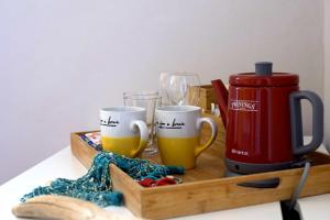 a tray with two mugs of beer and a thermos at ARIA DI MARE, Manarola - Camere con vista mare! in Manarola