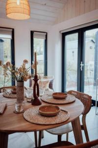 a wooden table with plates and vases on it at WØUD Tiny House in Epe