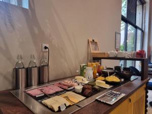 a buffet with meat cheese and other foods on a counter at ibis Styles Dijon Sud Domaine De Beauregard 21600 Longvic in Dijon