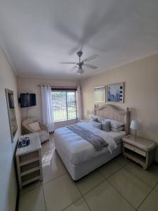 a bedroom with a large bed and a window at The Executive 5 BnB in Manzini