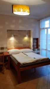 a bedroom with a large bed with a wooden headboard at Przy Bulwarze in Mielno