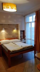 a large bed in a room with a window at Przy Bulwarze in Mielno