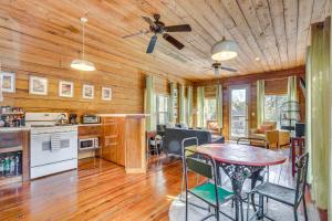 a kitchen and living room with a table and chairs at The Bird House Lush Bungalow, Steps from Ocean! in Folly Beach