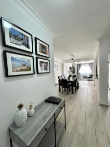 a living room with a table and a dining room at Princess Retreat Beautiful Modern Aprt 2 min walk from Quarteira Beach in Quarteira