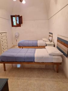 Postel nebo postele na pokoji v ubytování Dammuso Marino