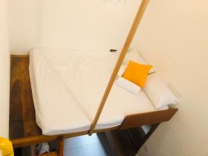 a room with a bunk bed with a yellow pillow at RedBrick House Rumassala in Galle