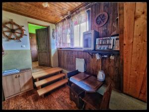 a room with a kitchen and a table in a cabin at Noclegi u Marka in Czernichów