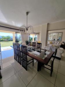 a dining room with a table and chairs at The Executive 5 BnB in Manzini