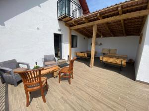 a patio with a wooden table and chairs at Holiday Nature House in Izvoare