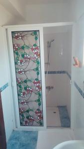 a bathroom with a glass door with a shower at Karpaz Stone House in Rizokarpaso