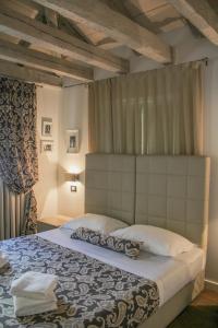 a bedroom with a large bed with a canopy at Barbacan Boutique Hotel in Trieste