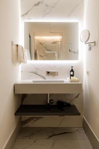 a bathroom with a sink and a mirror at ADOUNIA HOME in Naples