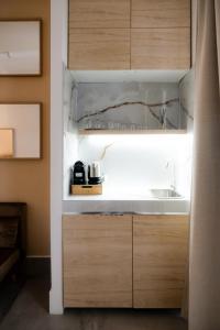 a kitchen with wooden cabinets and a sink at ADOUNIA HOME in Naples