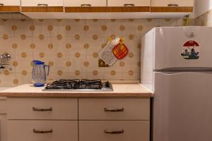 a kitchen with a stove and a refrigerator at Sunset House - Casa al Tramonto in Selva di Progno