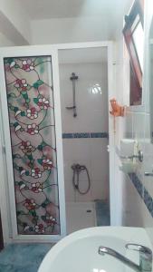 a bathroom with a shower and a white sink at Karpaz Stone House in Rizokarpaso