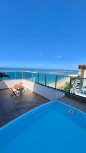 a view of the ocean from a swimming pool at Quarto in Vila Velha