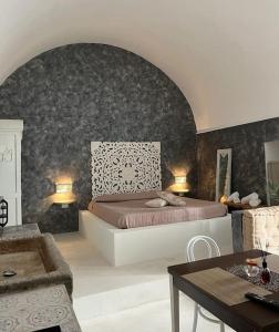 a bedroom with a large bed and a table at Tufo House in Matino