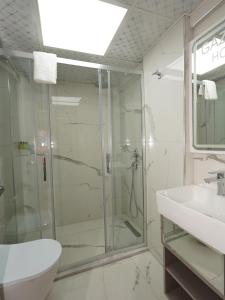 a bathroom with a glass shower and a sink at gazelle suites in Istanbul