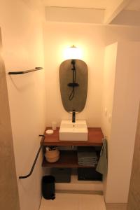 a bathroom with a sink and a mirror at Studio Kaza Blanka - Saint Leu - Réunion in Saint-Leu