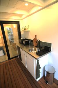 a kitchen with a sink and a counter top at Studio Kaza Blanka - Saint Leu - Réunion in Saint-Leu +2 photos