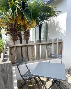 a table and a chair sitting on a patio at Fleur de Ré in Loix