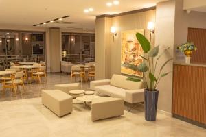 a lobby with couches and tables and a restaurant at First Joy Hotel in Trabzon