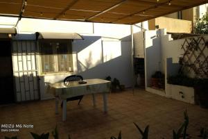 a patio with a table in the middle of a building at Casa Vittoria in Vignacastrisi