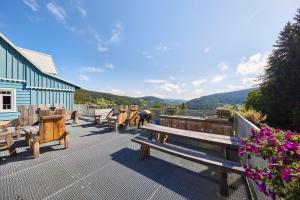 a group of benches sitting on a deck with a view at Horský dům Urlas in Pec pod Sněžkou