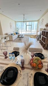 a living room with a table with plates of food at Wonderful two bed room with full marina view in Dubai