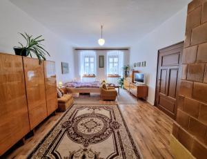 a large living room with a bed and a couch at Apartment in a historical house in the center of Levoča in Levoča