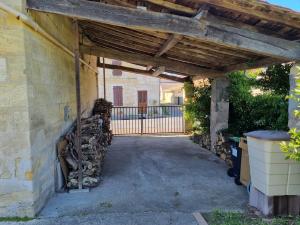an entrance to a building with a wooden pergola at 3 bedrooms, very quiet, fully equiped, between Bordeaux and Saint-Emilion in Vayres