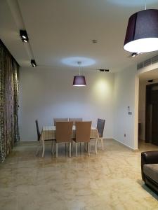 a dining room with a table and chairs at Saraya Al Olaya Tower family house in Al Khobar