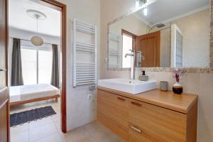 a bathroom with a sink and a mirror at City center, private parking, AC, 6ppl. in Olhão +17 photos