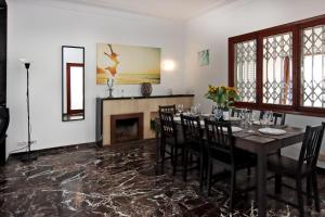 a dining room with a table and chairs and a fireplace at Villa Marbella by Slow Villas in Playa de Palma +34 photos