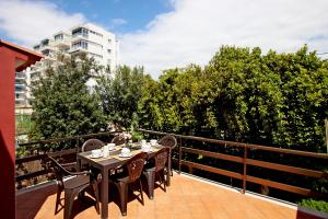 a table and chairs on the balcony of a building at Villa Marbella by Slow Villas in El Arenal +33 photos