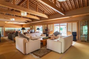 a living room with couches and a table at Oukai Villa Izumi in Izumi