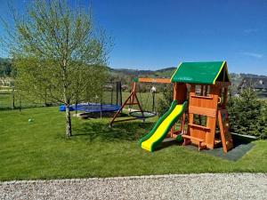 a playground with a slide and a swing at Chata Koziniec przy wyciągu in Czarna Góra