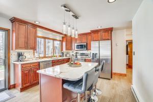a kitchen with wooden cabinets and a large island at Spacious Retreat 7 Mi to Tobyhanna State Park! in Tobyhanna