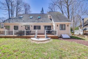 a home with a large porch and a house at Spacious Retreat 7 Mi to Tobyhanna State Park! in Tobyhanna