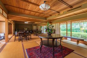 a dining room with a table and chairs at Oukai Villa Izumi in Izumi