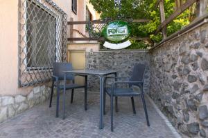 a black table and chairs on a patio at TonyHouse in Casal Palocco