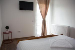 Postel nebo postele na pokoji v ubytování Pensiunea Teodora Caciulata