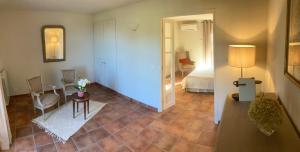 a room with a bedroom with a bed and a table at La Bastide de Villecroze in Villecroze