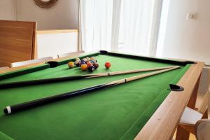 a pool table with balls on top of it at Chalet Cosy Nature in Alzon