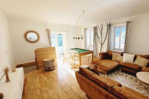 a living room with a couch and a table at Chalet Cosy Nature in Alzon